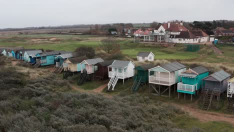 Slider-drone-shot-of-colourful-beach-huts-english-seaside