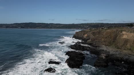 Aerial-view-of-waves-at-punta-de-lobos,-pichilemu-on-a-sunny-day