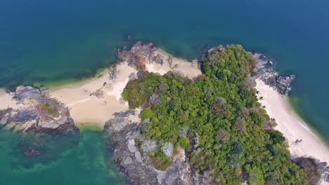 Slow-Panning-Aerial-of-Rocky-Coral-Fringed-Scenic-Island
