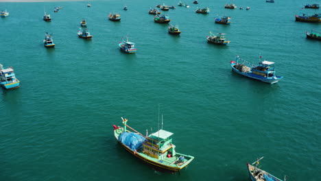 Many-fishing-boats-moored-on-coastline-with-Ke-Ga-Lighthouse-in-horizon