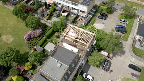 Aerial-of-wooden-frame-of-roof-structure-under-construction-in-a-suburban-neighborhood