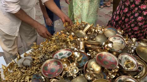A-brass-seller-shows-brass-statues-to-the-buyers-at-Janpath-market-in-New-Delhi