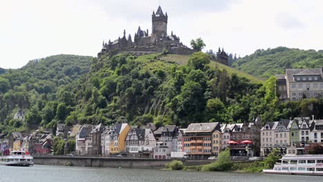 The-Reichsburg-towering-above-the-city-of-Cochem,-Germany-on-a-sunny-spring-day