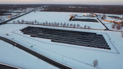 Aerial-view-of-field-with-solar-panels-covered-in-snow