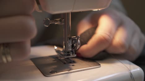 Woman-sewing---Close-up-of-sewing-needle,-textile,-and-hands