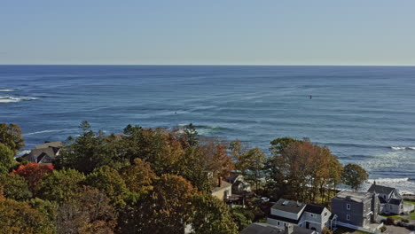 York-Maine-Aerial-v1-drone-fly-around-coastal-homes-at-cape-neddick-harbor-overlooking-at-beautiful-gulf-with-boat-cruising-on-the-water---October-2020