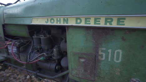 Slow-Motion-Shot-Of-A-Old-Green-John-Deere-Farming-Tractor,-Machine-For-Cultivating-Farms