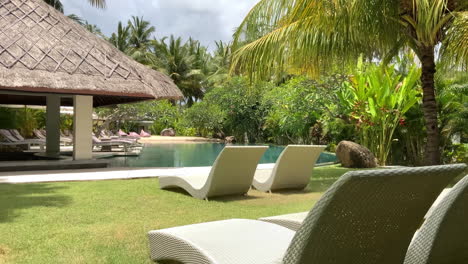 View-Of-Empty-Sun-Loungers-On-Grounds-Beside-Swimming-Pool-At-Tropical-Resort-Hotel-In-Lombok,-Indonesia