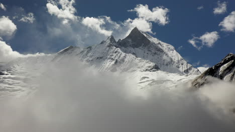 Aerial-drone-shot-of-a-cloudy-snowy-peak-in-the-Annapurna-mountains,-Nepal