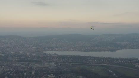 Paraglider-flying-through-a-city-landscape