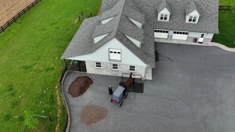 Aerial,-top-down-approach-of-Amish-couple-tying-up-horse