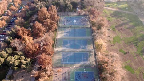 Aerial-view-dolly-in-of-the-sports-fields-of-Parque-Araucano,-Santiago,-Chile