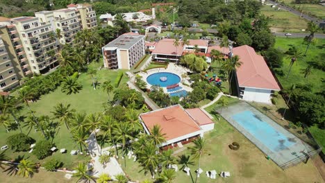 Aerial-footage-of-the-beach-on-a-sunny-day,-from-a-hotel-in-Costa-Rica,-Aerial-drone-images,-Beach-Jaco,-Puntarenas,-Costa-Rica,-Dolly-Tilt