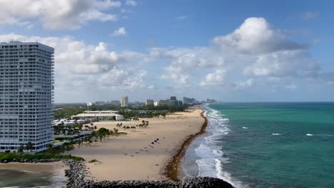 Fort-Lauderdale,-Florida-beach-and-hotels-on-sunny-day,-leaving-port