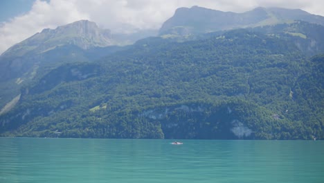 Interlaken,-Switzerland,-man-,surf-board,-lake,-mountains,-hillside,-Heavenly,-picturesque,-clouds,-wide-pan-view