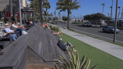 People-relaxing-enjoying-the-sunshine-at-Pacific-city-in-Huntington-Beach-California
