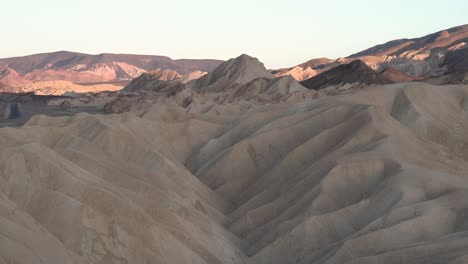 Sand-dunes-with-sun-coming-down-in-Death-Valley,-Mojave-Desert,-California,-Aerial-dolly-left-shot