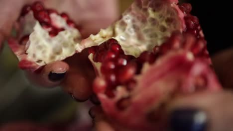 Peeling-pomegranate.-Opening-and-showing-red-seed