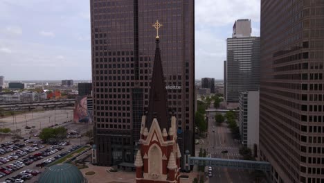 Aerial-view-around-the-bell-tower-of-the-Cathedral-Shrine-of-the-Virgin-of-Guadalupe,-in-Dallas,-USA---circling,-drone-shot