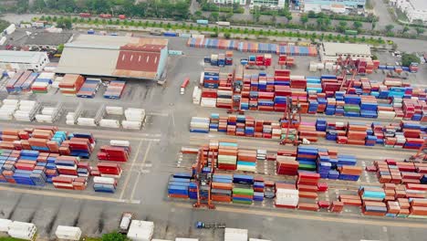 Aerial-tilt-down-reveals-containers-stacked-at-terminal