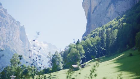 Tourists,-Walking,-Meadow,-grass,-cottage,-waterfall,-mountain,-Lauterbrunnen,-Switzerland