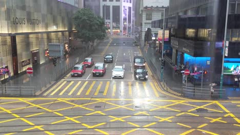 Public-transport-driving-on-Hong-Kong-street-in-Central-financial-district-during-rain-storm