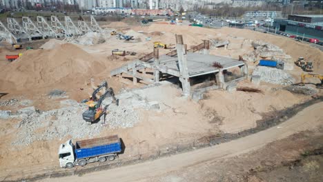 AERIAL:-Heavy-Machinery-Digs-Rubble-of-National-Stadium-in-Vilnius-and-Puts-It-in-Truck