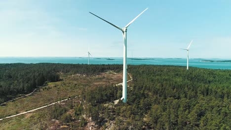 Aerial-tracking-shot-of-some-static-wind-turbines-on-an-island-in-the-Finnish-archipelago