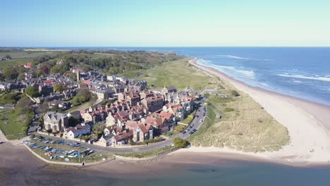 Aerial-view-looking-from-south-to-north-of-the-village-of-Alnmouth-on-the-northumberland-coast,-UK