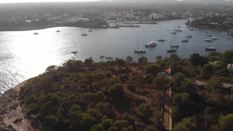 AERIAL:-Beautiful-Harbor-with-luxury-boats-at-sunset-in-Mallorca,-spain