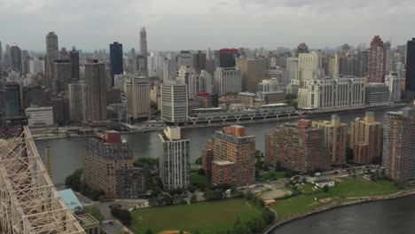 Drone-aerial-shot-flying-towards-Manhattan-NYC-from-Roosevelt-Island-and-Queens-next-to-Queensboro-Bridge-in-the-daytime