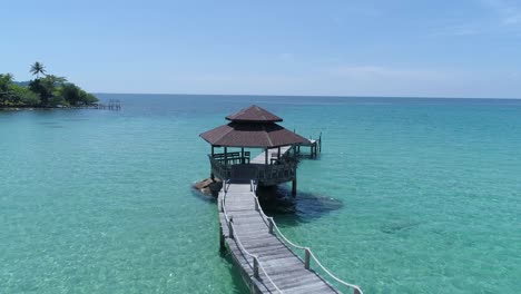 Aerial-of-gazebo-on-a-dock-out-in-the-ocean-on-a-tropical-island,-Koh-Kood,-Thailand