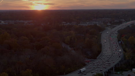 Aerial-of-highway-traffic-at-rush-hour-at-sunset-in-Autumn