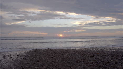 Costa-Rica-Beach-with-the-sun-setting-in-the-distance