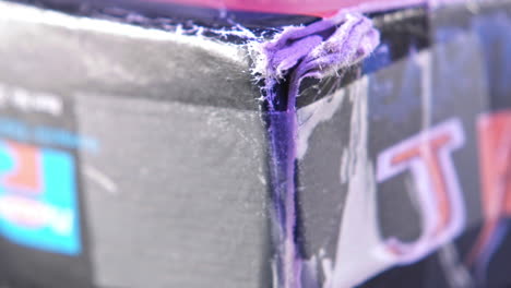 Taped-Corner-of-Vintage-Super-Nintendo-Game-Box-in-Purple-Light-SLIDE-LEFT