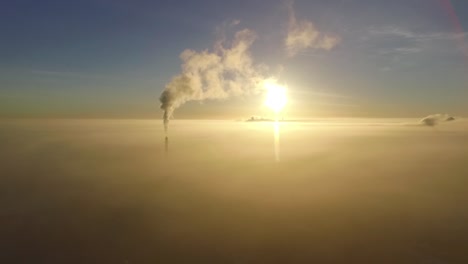 Dense-fog-over-city-Valmiera-in-early-winter-morning-sunlight-aerial-footage-wide-shot