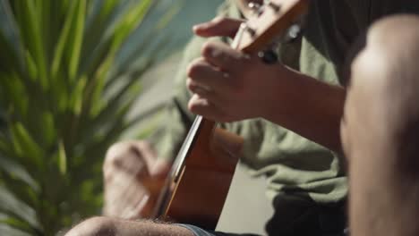 Side-View-of-a-Man-Playing-a-Ukulele