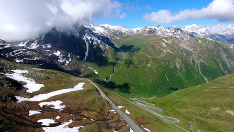 Aerial-shot-of-Nufenenpass-Early-summer-with-unmelted-patches-of-snow