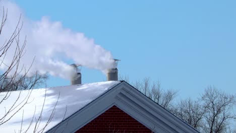 A-couple-round-shaped-household-chimneys-releasing-white-smoke-into-the-air