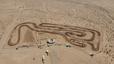 High-aerial-drone-view-of-motocross-circuit-racing-in-Mojave-Desert,-California