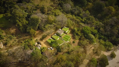 Drone-circling-around-a-beautiful-home-in-a-tropical-rainforest
