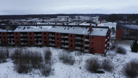 Aerial-view-over-abandoned-house-during-winter