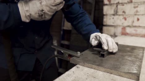worker-with-helpet-is-welding-the-metal