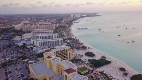 Aerial-sweep-of-the-coastline-of-Aruba-and-the-blue-sea-during-sunset