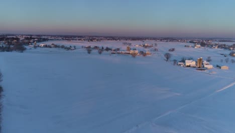 Aerial-View-of-Early-Morning-Sunrise-After-a-Snow-Fall-in-Amish-Countryside-as-Senn-by-s-Drone