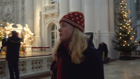 Blonde-woman-looking-around-the-inside-of-the-Theatiner-Church-in-Munich