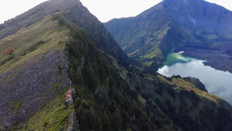 Beautiful-Pan-Up-Aerial-Panoramic-View-of-Campers-on-Rinjani-Mountain-In-Indonesia