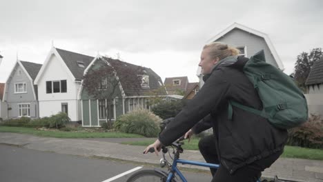 Girl-rides-a-bicycle-on-a-cold-day,-in-south-of-Amsterdam