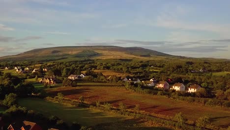 Aerial-pass-over-rural-Irish-village-near-large-lake