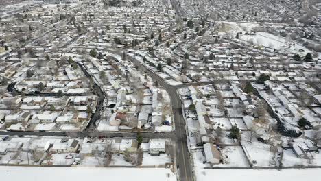 Drone-pans-over-snow-covered-neighborhood